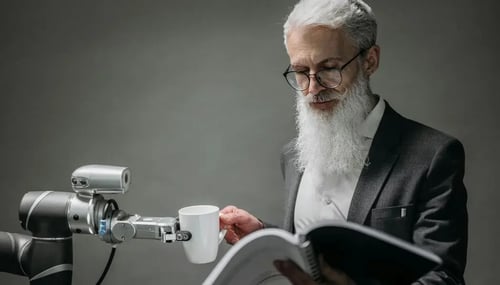 man reading a manual and handing a cup to a robot