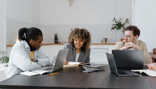  Three people sitting and working on laptops 