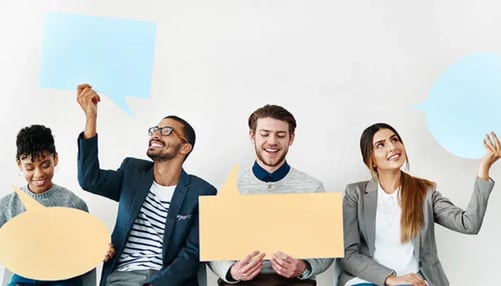 A diverse group of individuals sitting on a couch, each holding a speech bubble, engaged in a conversation 