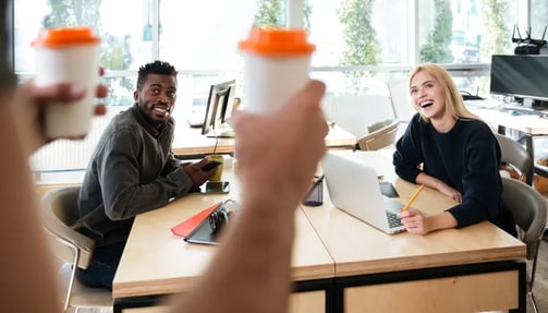 smiling young colleagues sitting office coworking