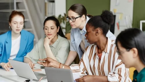 women from different ethnicity sitting in a workplace